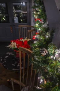 Christmas tree decorated with red berries and ornaments for the holidays.