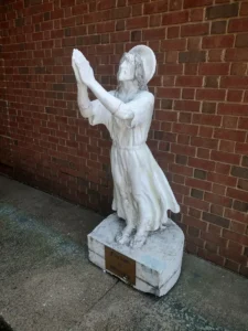statue of a praying figure.