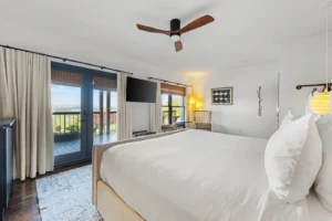 Room with king bed, mountain view, and patio doors.