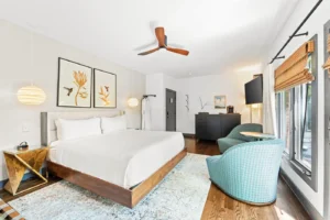 Bedroom with king bed, seating area, and large window
