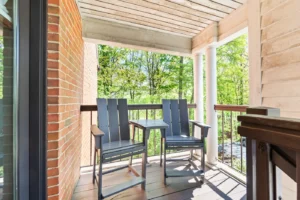 Two rocking chairs on a porch.