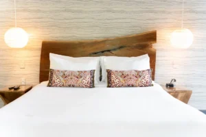 bedroom with a wooden headboard and patterned pillows.