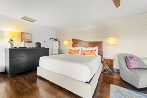 A bedroom featuring a neatly made bed with decorative pillows.