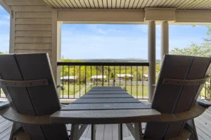 A table and chairs set on a porch.