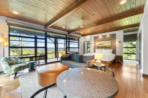 Room with sofa, table, and scenic view.