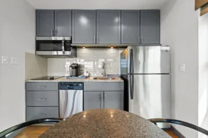 kitchen with white cabinets and a refrigerator.