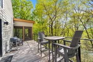 Scenic deck with seating, overlooking trees.