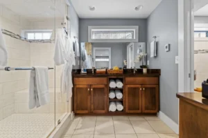 Luxury bathroom with double vanity, walk-in shower, and plush towels.