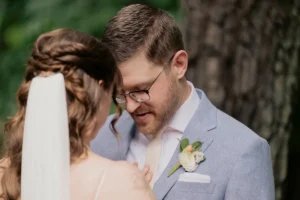 Bride and groom share a tender moment during their wedding ceremony.